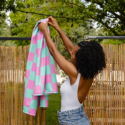 Toalha de banho cor-de-rosa e azul em padrão de riscas quadradas