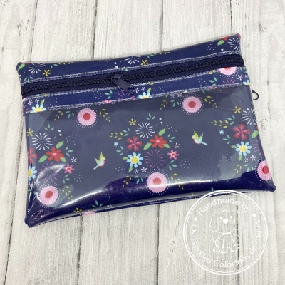Estojo plástico azul escuro com flores e pássaros coloridos.