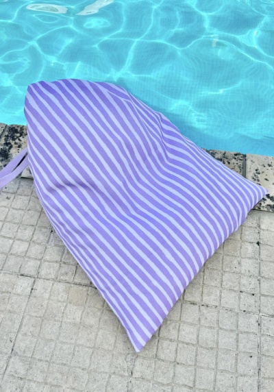 Saco riscas brancas e lilás junto à piscina