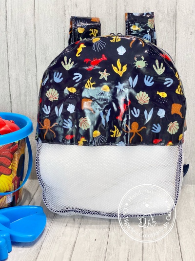 Mochila infantil com padrão marinho colorido e parte inferior em rede branca