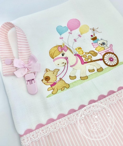 Toalha branca com riscas rosa, renda, fita ondulada e ilustração bordada de cavalo, cão e gato com balões.