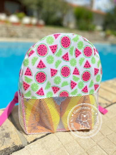 Mochila pequena colorida ao lado de piscina