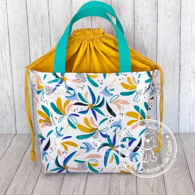 Bolsa estampada com folhas coloridas e interior amarelo