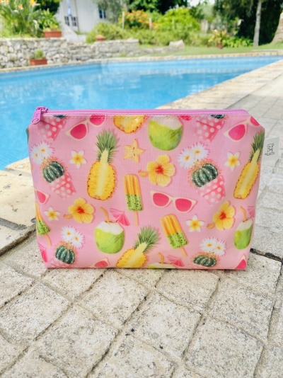 Estojo cor-de-rosa com padrão de frutas tropicais junto à piscina