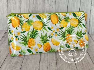 Necessaire com padrão de abacaxis amarelos e folhas verdes