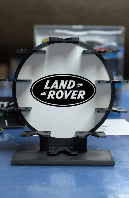 Suporte redondo preto com logotipo Land Rover em branco e preto