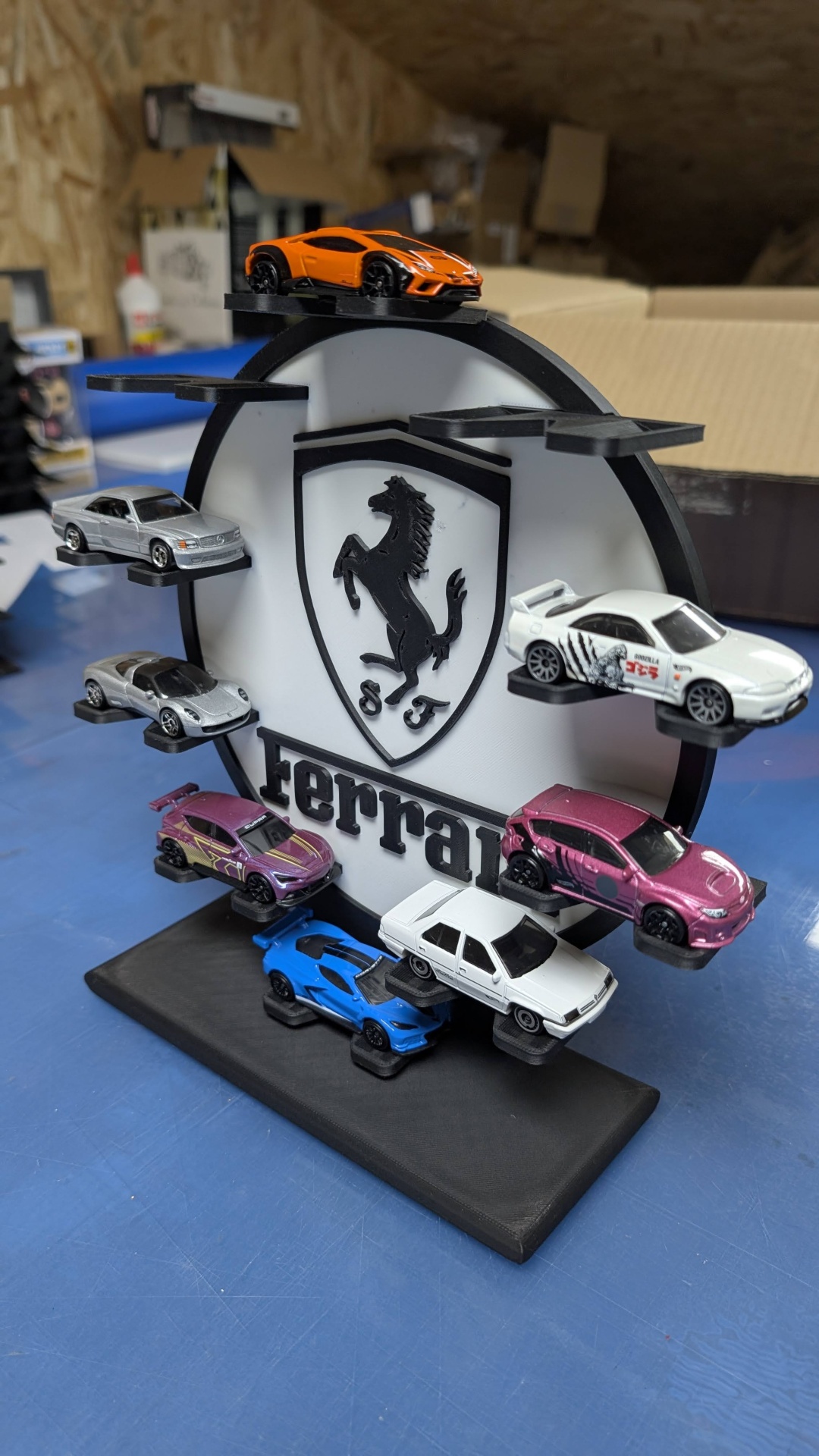 Expositor circular com miniaturas de carros e logótipo Ferrari preto