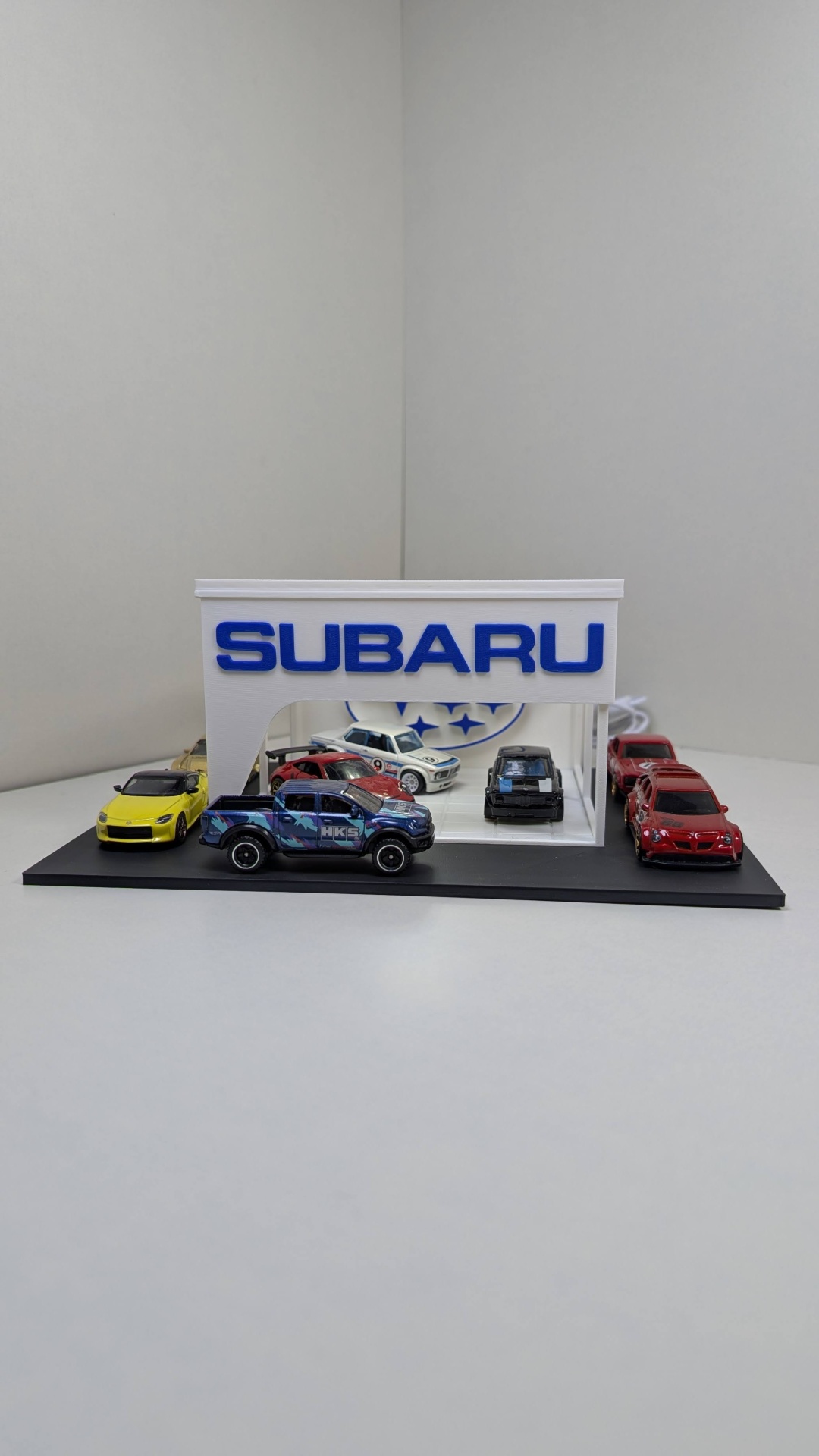 Miniaturas de carros em base com estrutura SUBARU azul e branca