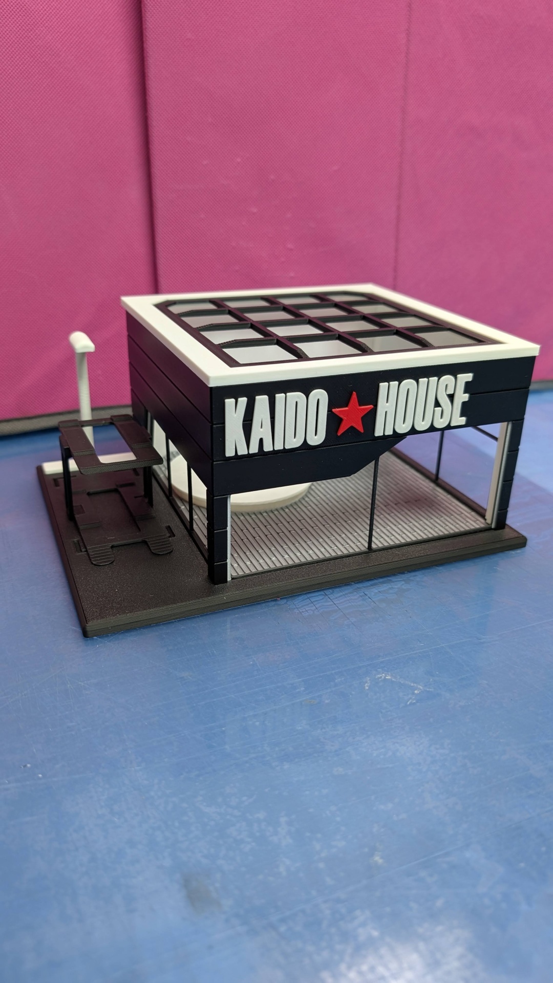 Miniatura de edifício preto e branco com fachada escrita KAIDO HOUSE