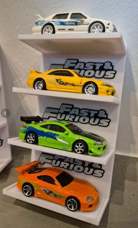 Quatro carros em miniatura coloridos em suporte Fast & Furious