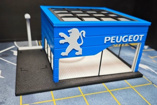 Modelo miniatura de garagem Peugeot azul com base preta