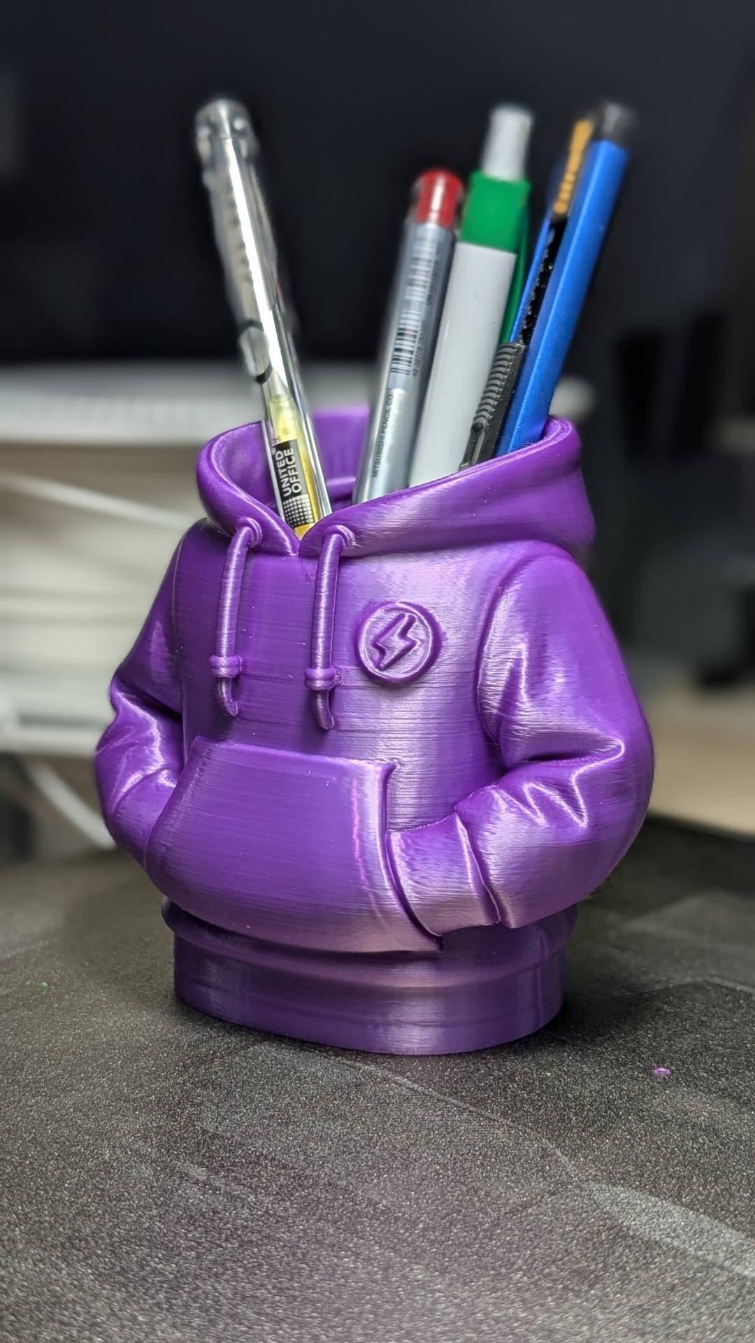 Suporte para canetas lilás em forma de capuz com canetas dentro