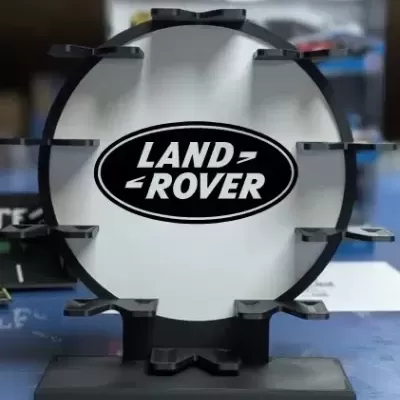 Suporte redondo preto com logotipo Land Rover em branco e preto