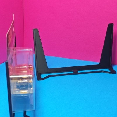 Suporte preto para consola ou equipamento eletrónico em fundo azul e rosa