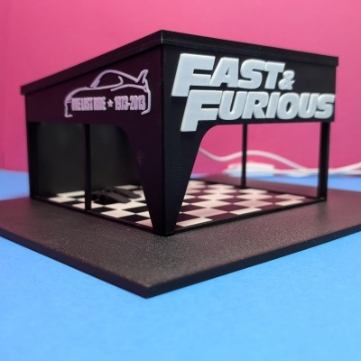 Modelo tridimensional preto com base quadrada e inscrições Fast & Furious