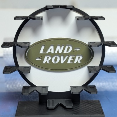 Suporte preto circular com emblema oval verde de Land Rover