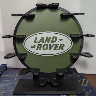 Suporte com logótipo Land Rover em verde e preto com várias saliências para apoio