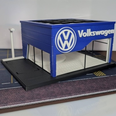 Miniatura de concessionária Volkswagen azul com logótipo e texto branco