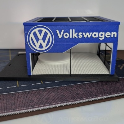 Miniatura de fachada Volkswagen azul com logótipo branco