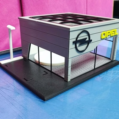 Miniatura de loja Opel cinza com vidros e base preta