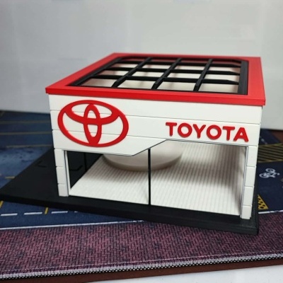 Miniatura de loja Toyota com logotipo e fachada em branco, vermelho e preto