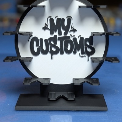 Suporte preto e branco com texto MY CUSTOMS e prateleiras pequenas para exposição de objetos