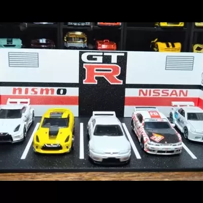 Miniaturas de carros Nissan GT-R em exposição com fundo decorado