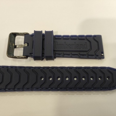 Correia de relógio em borracha azul escura com fivela metálica e padrão texturizado.