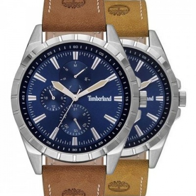 Dois relógios Timberland com mostradores azuis e pulseiras de pele castanha e bege.