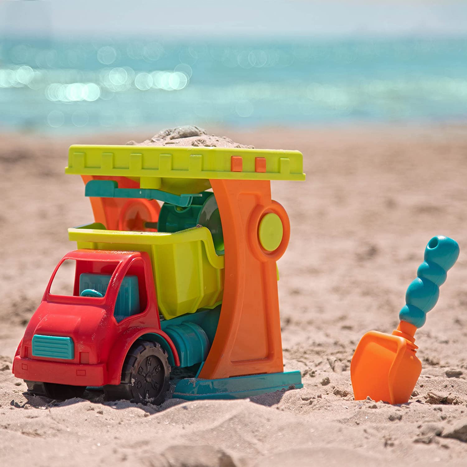 Sandy Sifter Set Carrinho de brinquedo colorido e pá na praia junto ao mar