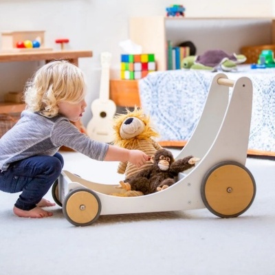 Brinquedo de empurrar de madeira com peluches em ambiente infantil