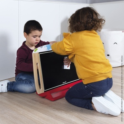 Duas crianças a brincar com um quadro negro de madeira decorado