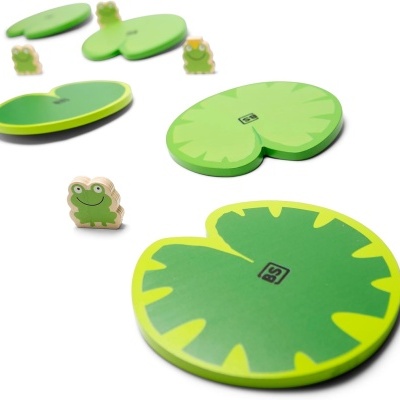 Peças de jogo em madeira com padrão de folhas verdes e figuras de rãs pequenas.