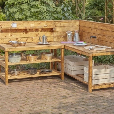 Cozinha exterior de madeira com utensílios e prateleiras ao ar livre