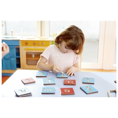 Criança a jogar com cartas coloridas numa mesa