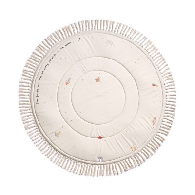 Tapete redondo almofadado em algodão cru com franjas largas na borda e desenhos pequenos coloridos.