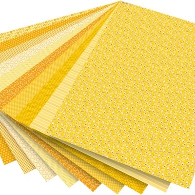 Folhas de papel decorativo amarelo e laranja com padrões variados