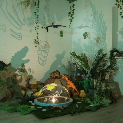 cenário infantil de dinossauros com vegetação e sombras na parede