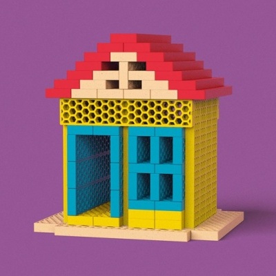 Modelo de casa em blocos coloridos com telhado vermelho e parede azul.