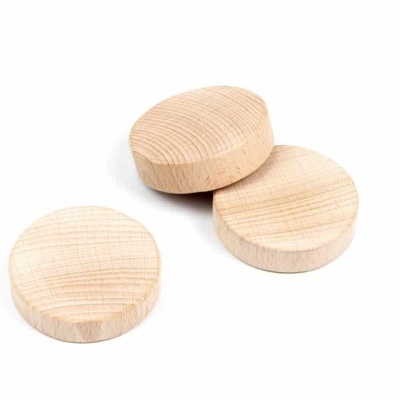 Três peças redondas de madeira clara com textura de grão