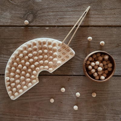 Jogo de sementeira em madeira com tabuleiro semi circular, pinças e bolinhas claras