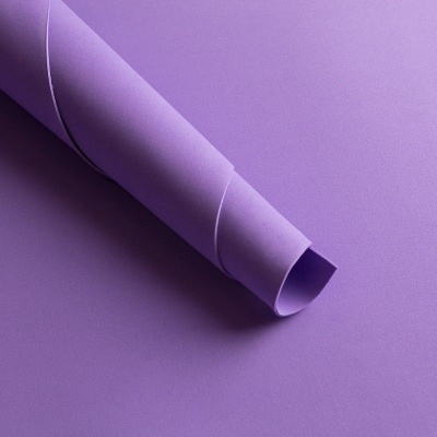 Rolo de papel roxo sobre superfície roxa lisa