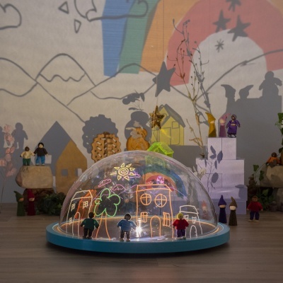 Cúpula transparente com desenhos coloridos e miniaturas ao redor