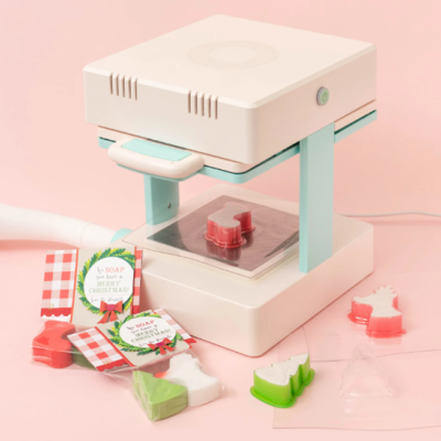 Máquina para moldar sabonetes com sabonetes coloridos em forma de Natal e etiquetas decorativas