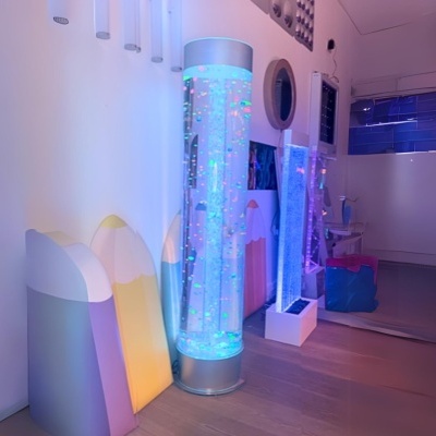 Luminárias decorativas coloridas em ambiente interno com chão de madeira.