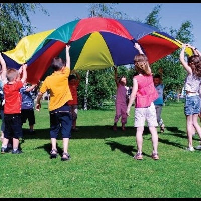 Crianças segurando tecido colorido em parque