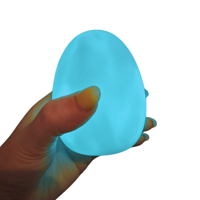 Objeto azul em forma de ovo segurado por mão em fundo branco