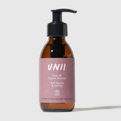 Frasco de óleo puro UNII com doseador preto e rótulo rosa