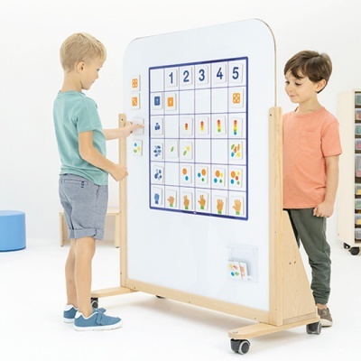 Quadro branco vertical com tabela magnética educativa e crianças interagindo