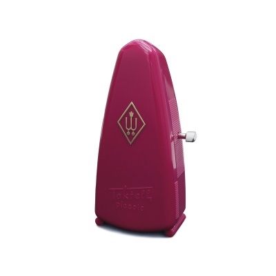 Metrónomo cor-de-rosa com botão metálico e símbolos dourados